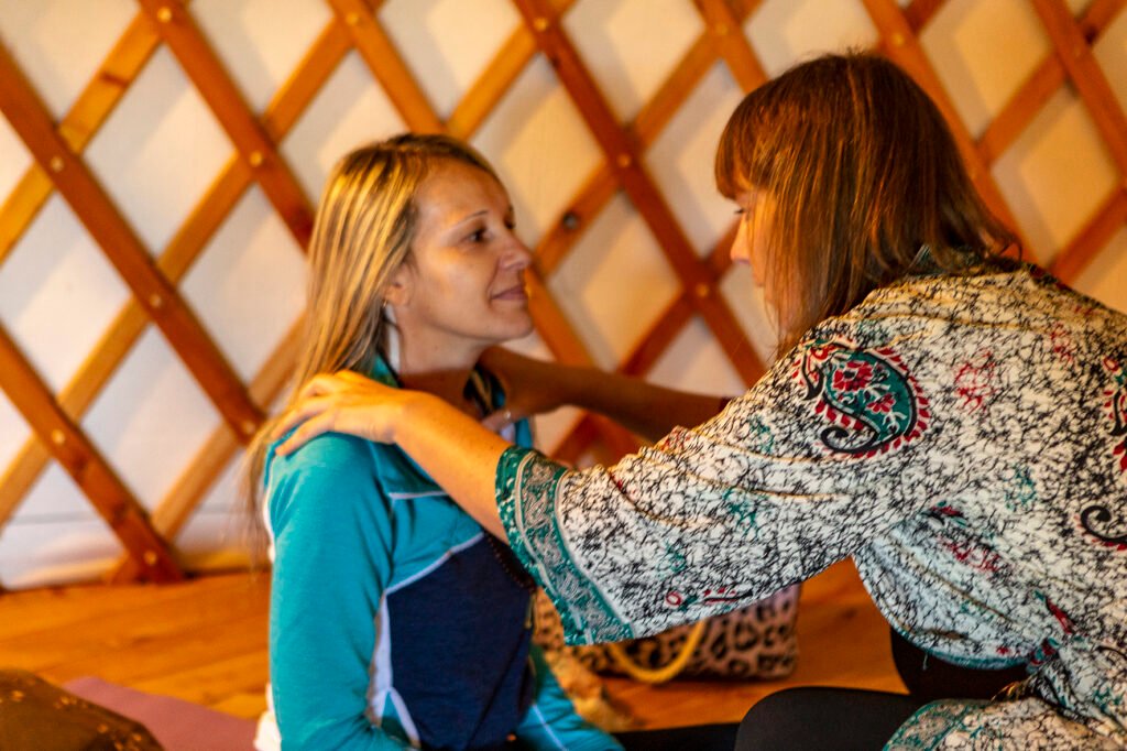 Nastassja Ugolini performing a kinesiology muscle test on a student during a somatic bodywork training.